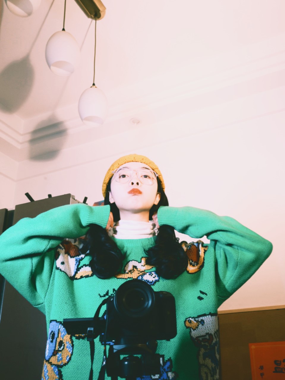 Jeanine White smiling in a red plaid shirt and tortoise shell glasses